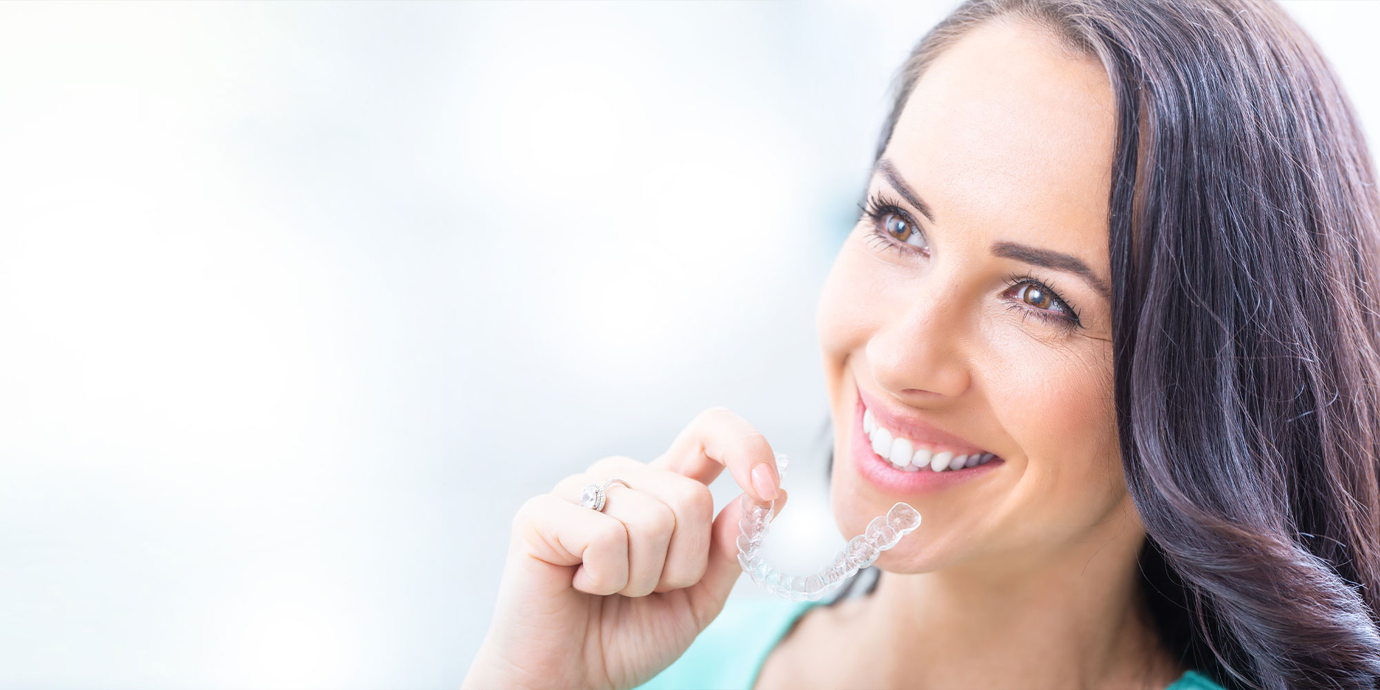 young women putting on their Invisalign