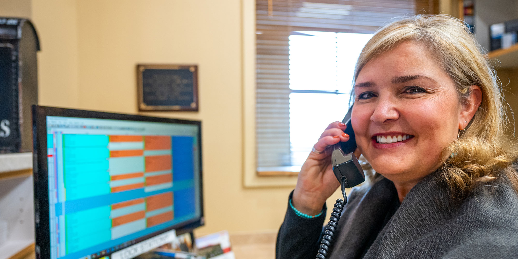 staff member at the front desk answering phone calls and