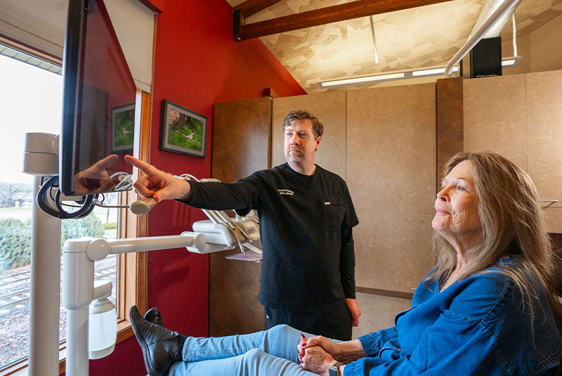 doctor and aptient going over dental procedure information within the dental center