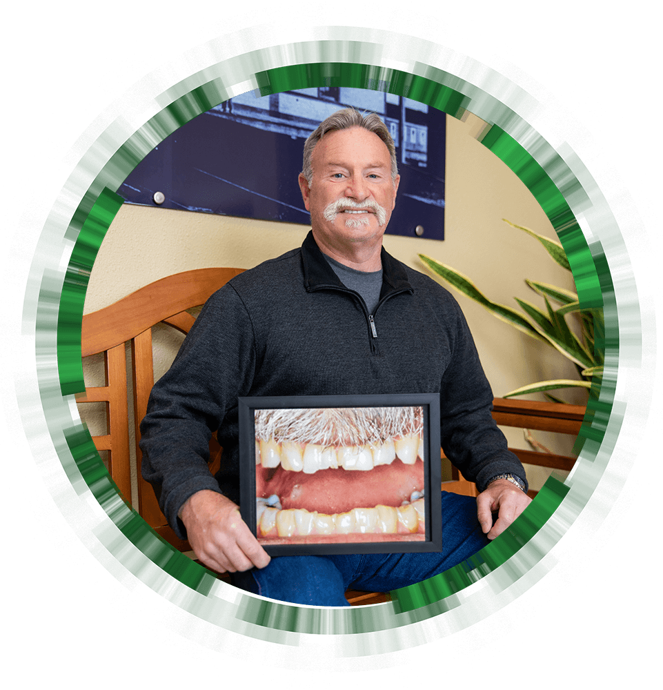 patient holding their before procedure frame and smiling