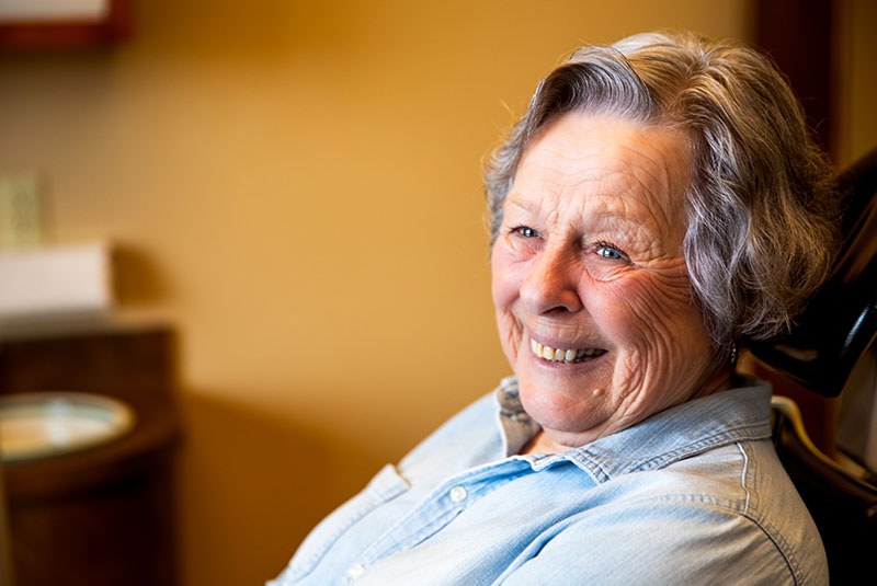 patient smiling brightly within the dental center