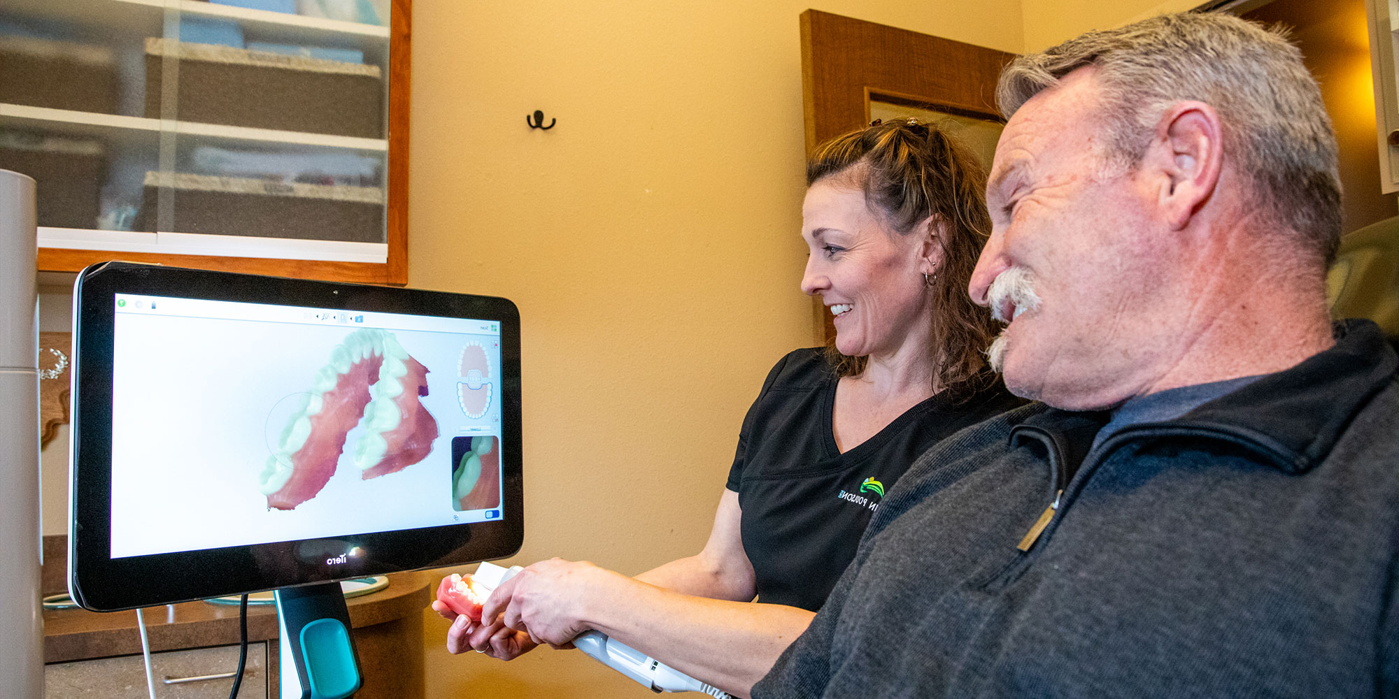 staff member and patient going over dental procedure information
