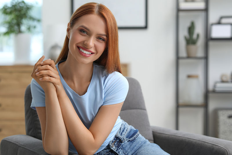 young model smiling with in the comfort of their own home