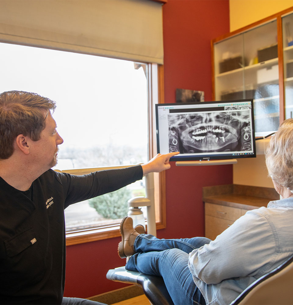 doctor going over dental procedure information within the dental center