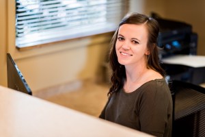 Dental Assistant Abigail at the front desk of the practice