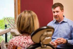 Dr. Poulson advising a patient in examination room